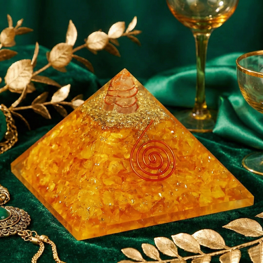Decorative pyramid with a spiral design on a green fabric background with gold leaves and a glass.