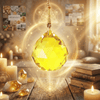 Decorative crystal ball with candles and books on a wooden surface