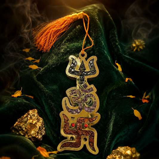 Decorative hanging ornament with intricate designs on a dark green fabric background.