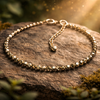 Gold bracelet on a stone surface with a natural background