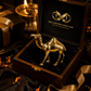 Gold camel figurine in a wooden box with 'Millionaires Mind Hub' branding, surrounded by decorative items.