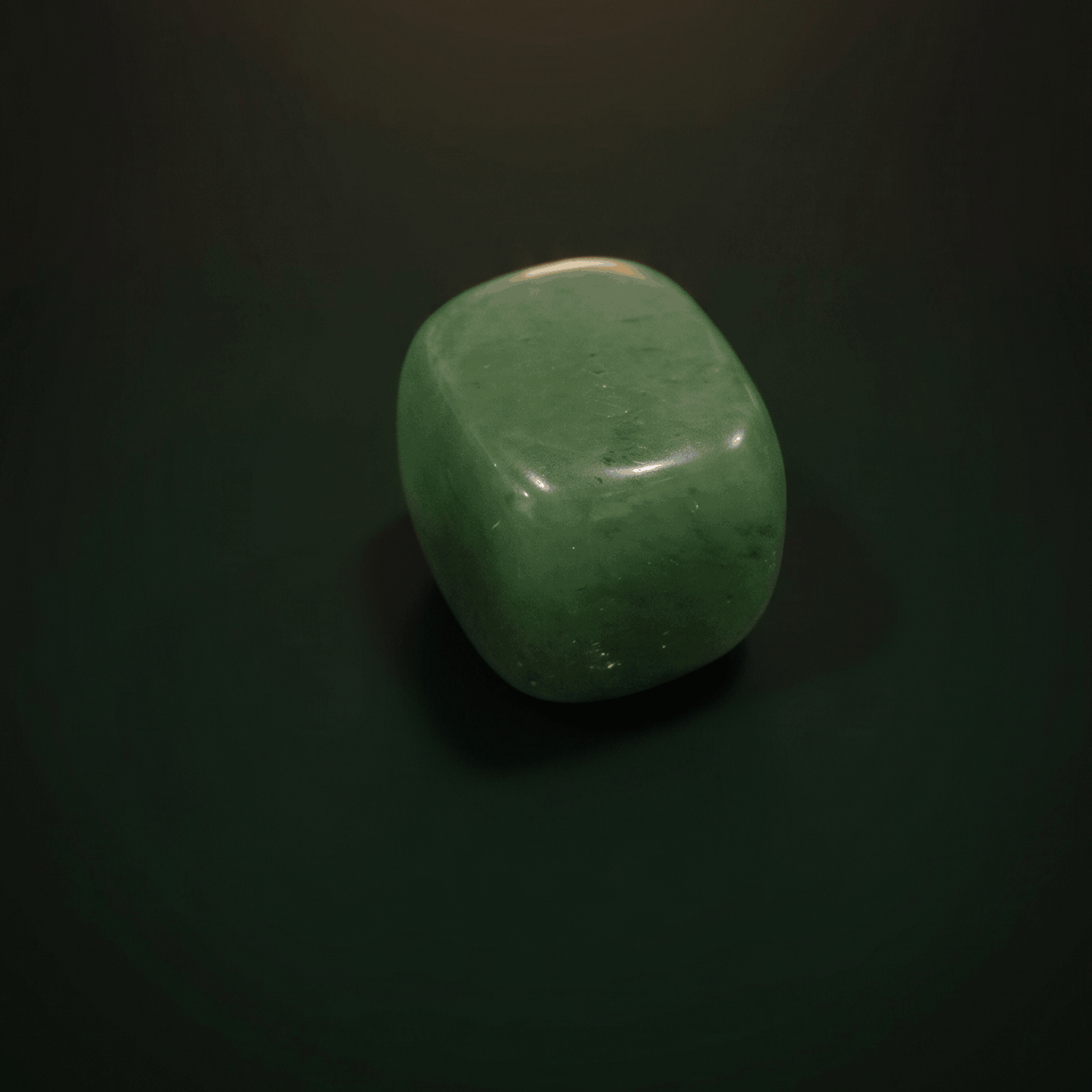 Green jade stone on a dark background