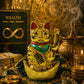 Gold cat figurine with green belly and black text, surrounded by coins and books on wealth.