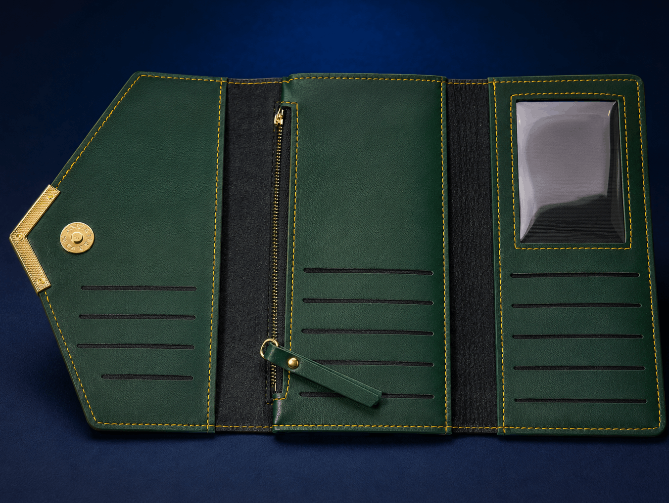An open dark green leather wallet or organizer case with gold-tone hardware, shown on a dark blue background. The interior features card slots, a zipper compartment, elastic bands, and a clear ID window.