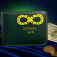 A dark green bifold wallet with yellow stitching and a yellow horseshoe-and-four-leaf clover logo, plus the words 'Infinite luck' on the front. The wallet is styled on a blue velvet surface with gold coins and a banknote nearby.