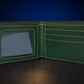 An open dark green leather bifold wallet with bright yellow contrast stitching, featuring an ID window on the left and card slots on the right, set against a dark blue background.
