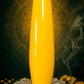 Yellow cylindrical object on a dark background with decorative elements