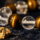 Close-up of tiger's eye and clear crystal balls on a dark surface