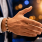 Hand wearing a bracelet with a blurred background