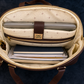 Open beige laptop bag with compartments on a dark background