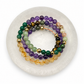 Set of colorful beaded bracelets on a white round stand
