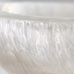 Close-up of a textured white surface with a light reflection