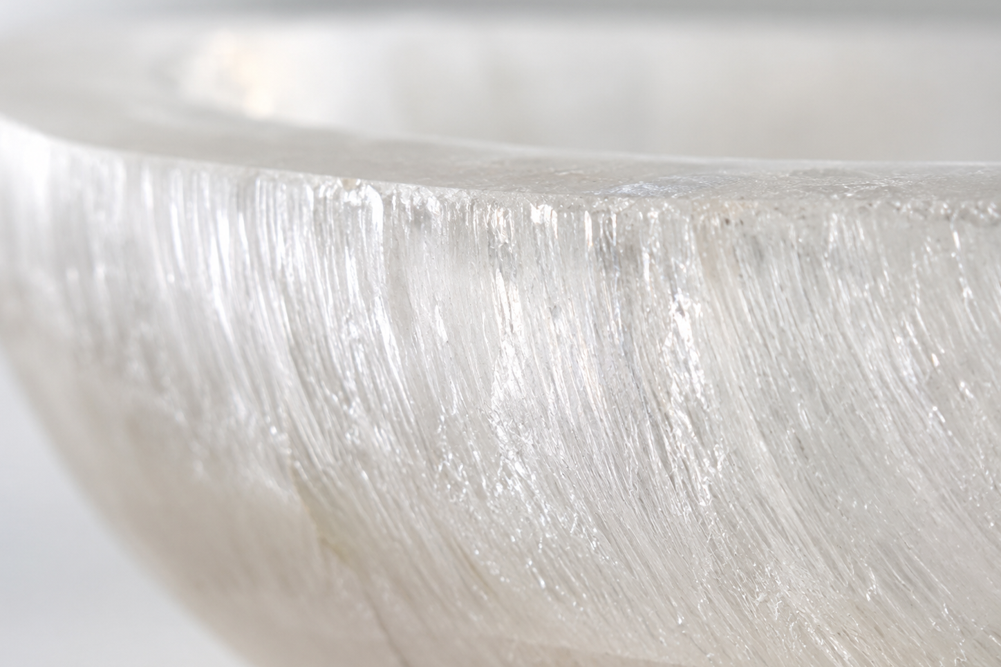 Close-up of a textured white surface with a light reflection