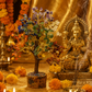 Decorative setup with a statue, flowers, and incense in front of a gold background