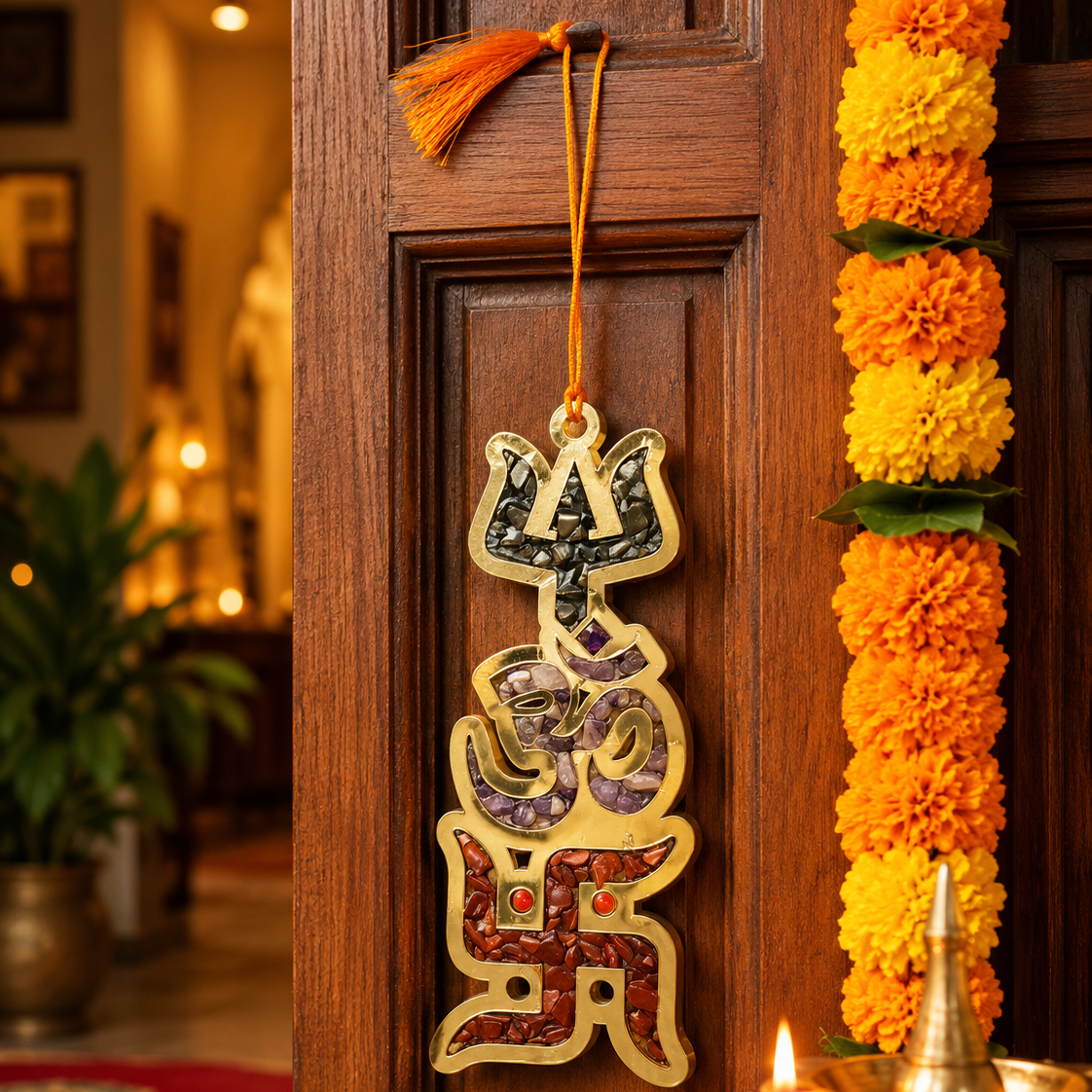Decorative Swastika symbol hanging on a wooden door with marigold garlands.
