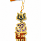 Decorative hanging charm with symbols and tassel on a white background