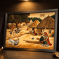 Framed artwork depicting a village scene with people and animals on a dark surface.