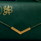 A promotional collage showing several dark green wallet and envelope-style wallet products with gold embroidery and coin graphics, under the text 'NEW ARRIVALS WEALTH WALLET COLLECTION' and 'MILIONAIRE'S MIND HUB'.