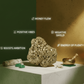Decorative setup with a large rock, green stones, and a small bowl on a white platform against a green and brown gradient background.